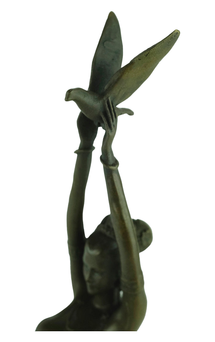 Modern bronze sculpture of a female releasing a bird