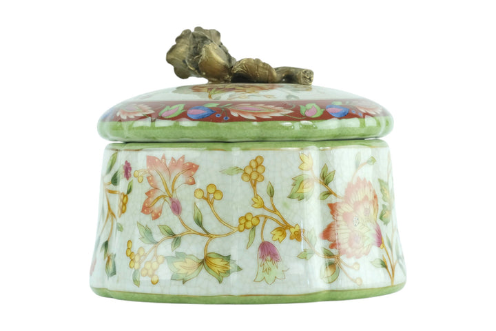Porcelain box with floral decoration and a bronze rose on the lid