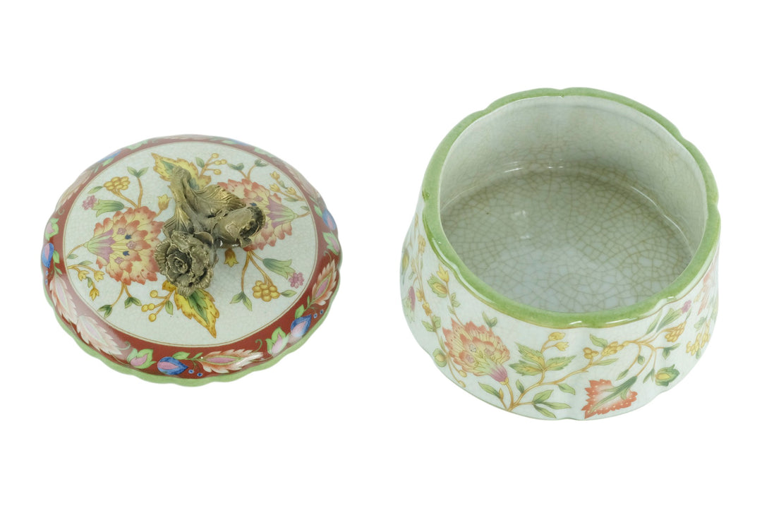 Porcelain box with floral decoration and a bronze rose on the lid