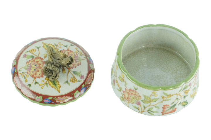 Porcelain box with floral decoration and a bronze rose on the lid