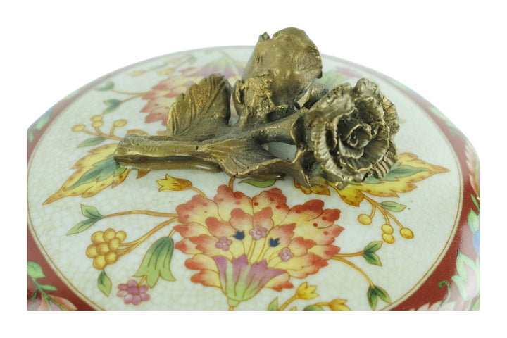 Porcelain box with floral decoration and a bronze rose on the lid