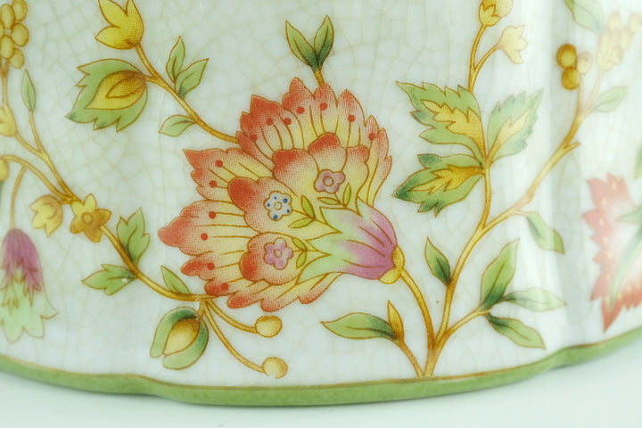 Porcelain box with floral decoration and a bronze rose on the lid
