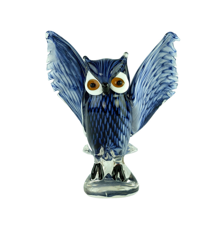 Colourful glass sculpture of an owl with wings spread