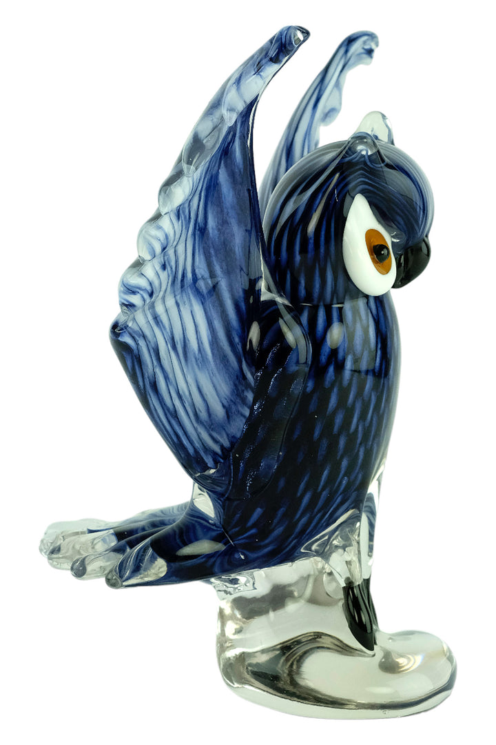 Colourful glass sculpture of an owl with wings spread