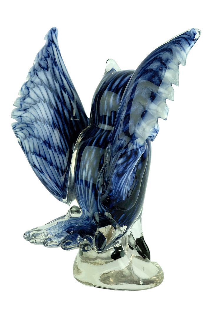 Colourful glass sculpture of an owl with wings spread