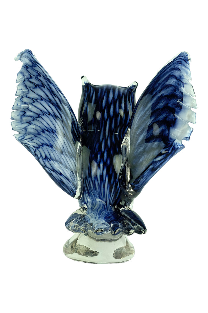 Colourful glass sculpture of an owl with wings spread