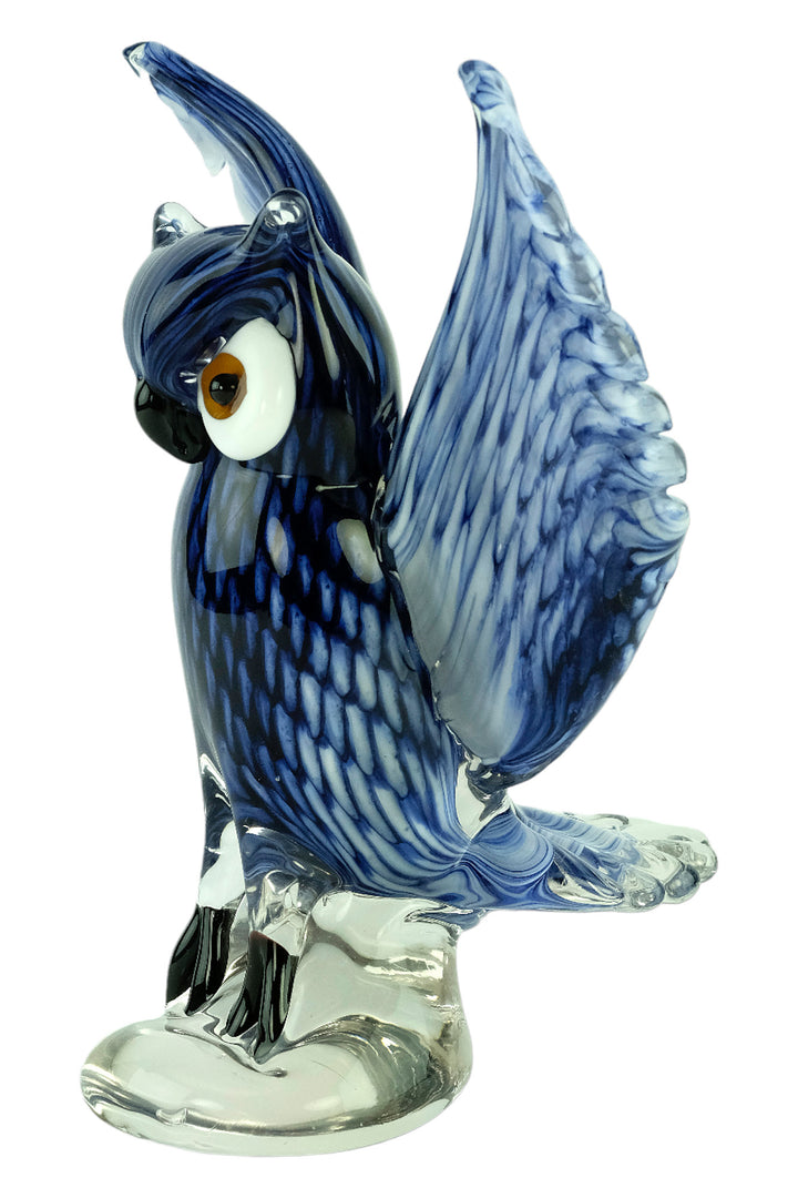 Colourful glass sculpture of an owl with wings spread