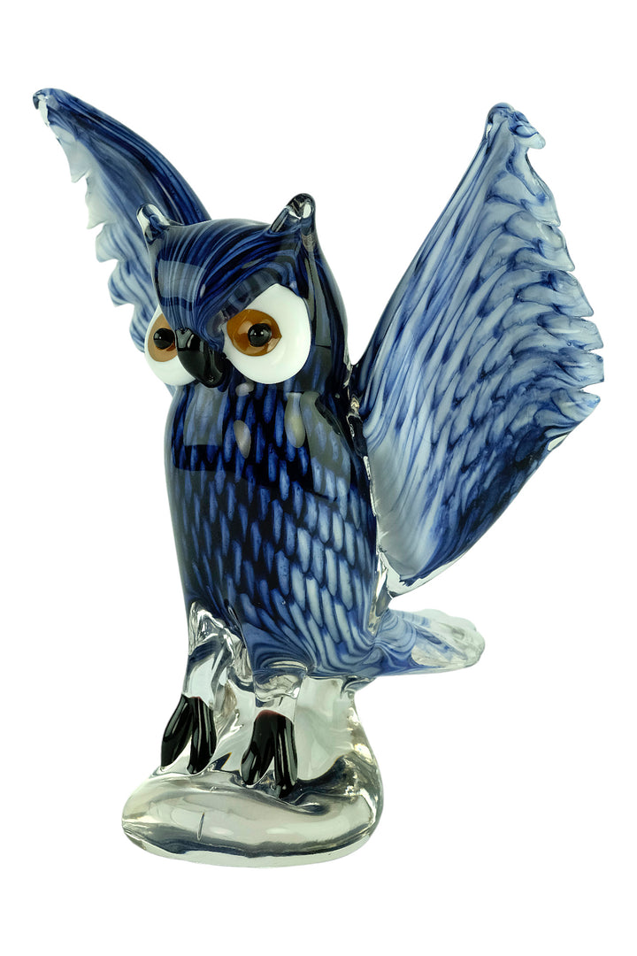 Colourful glass sculpture of an owl with wings spread