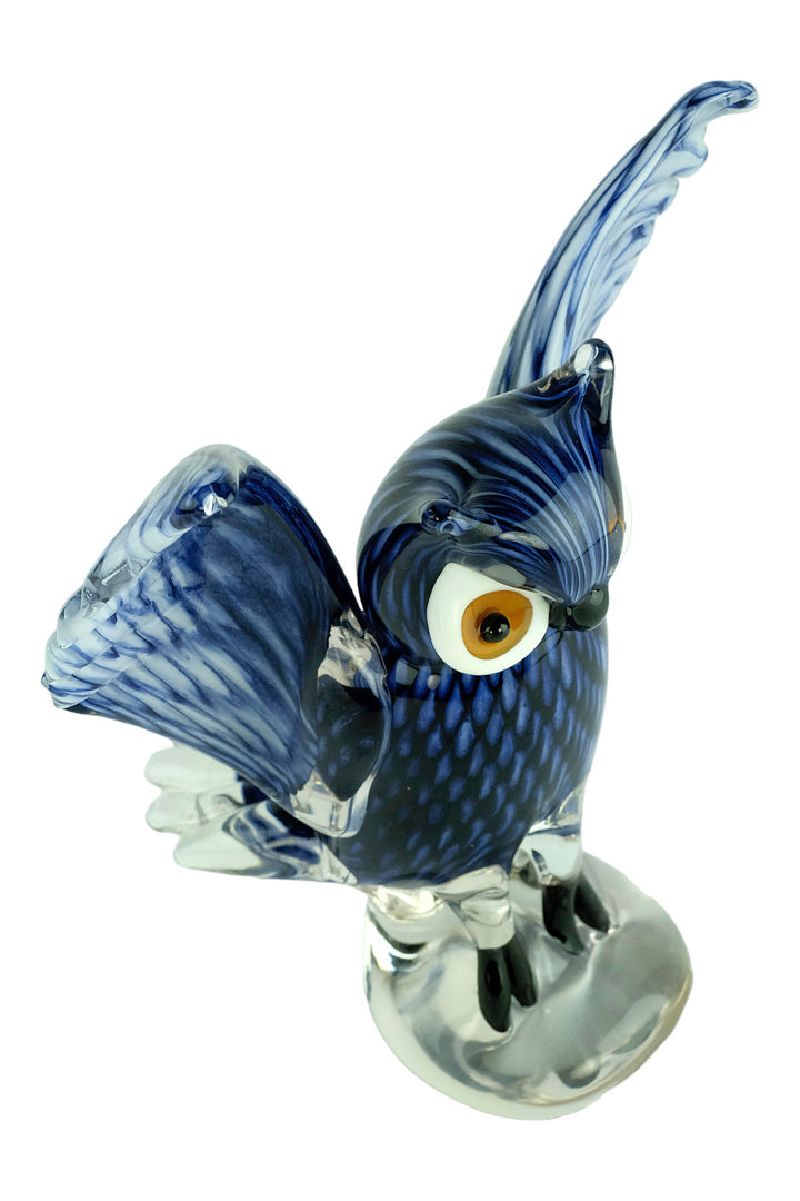 Colourful glass sculpture of an owl with wings spread