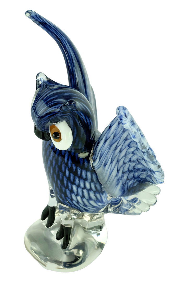 Colourful glass sculpture of an owl with wings spread