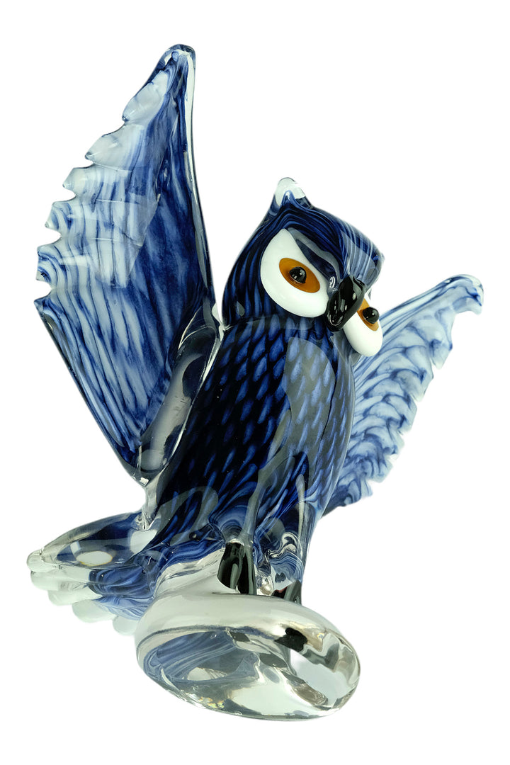 Colourful glass sculpture of an owl with wings spread