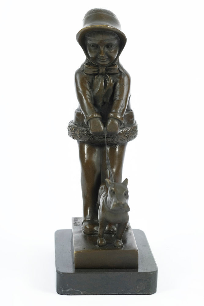 Bronze sculpture of a young girl walking her dog