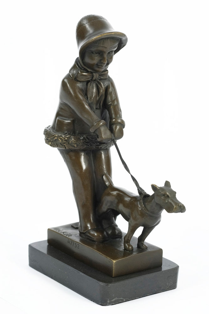 Bronze sculpture of a young girl walking her dog