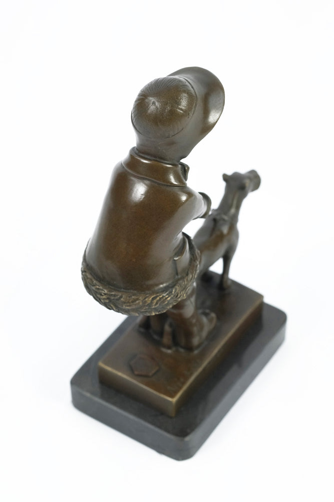 Bronze sculpture of a young girl walking her dog
