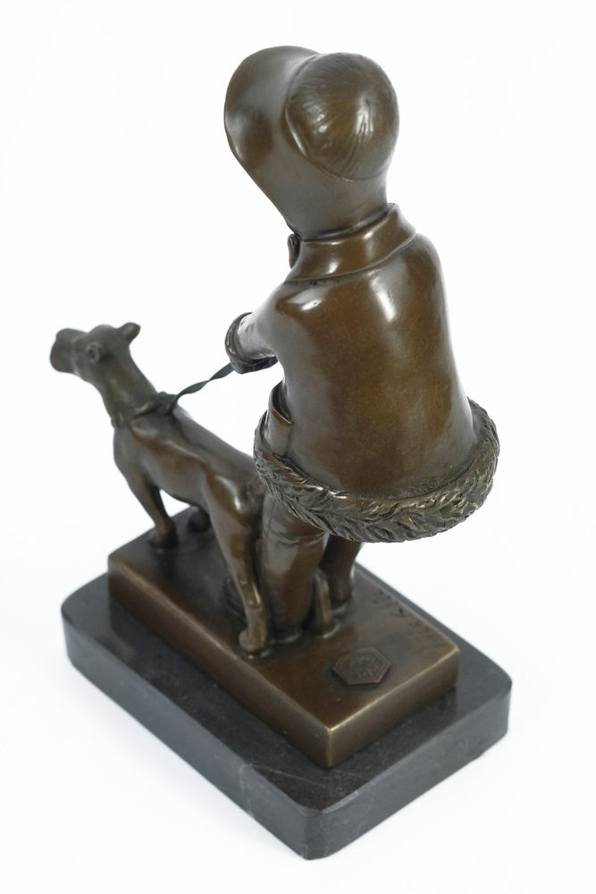 Bronze sculpture of a young girl walking her dog