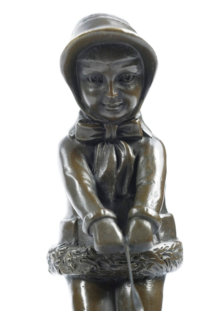 Bronze sculpture of a young girl walking her dog