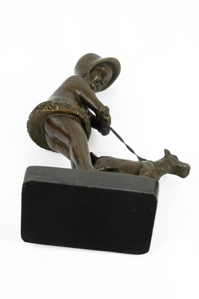 Bronze sculpture of a young girl walking her dog