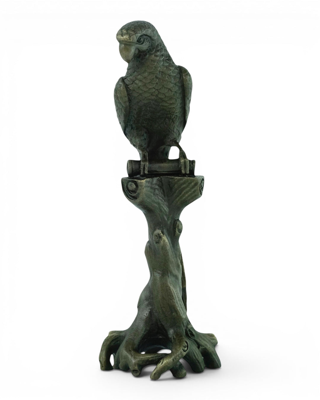 Bronze sculpture of a macaw sitting on a tree trunk