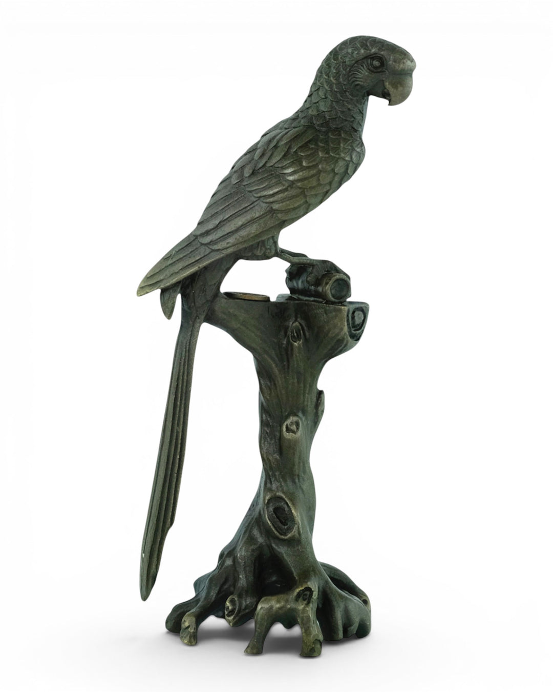 Bronze sculpture of a macaw sitting on a tree trunk