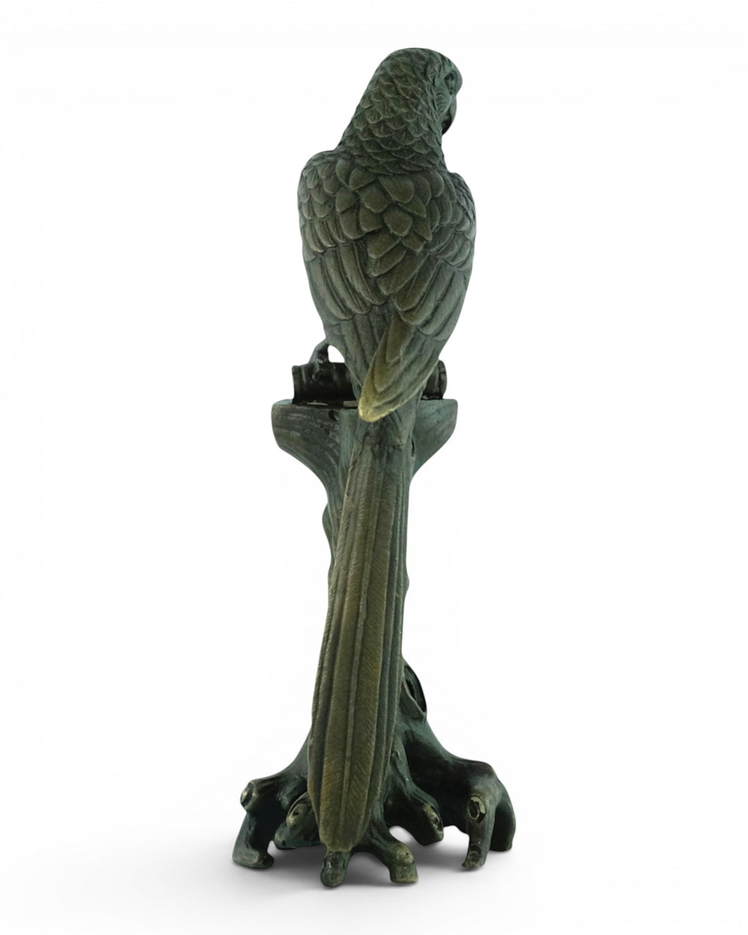 Bronze sculpture of a macaw sitting on a tree trunk
