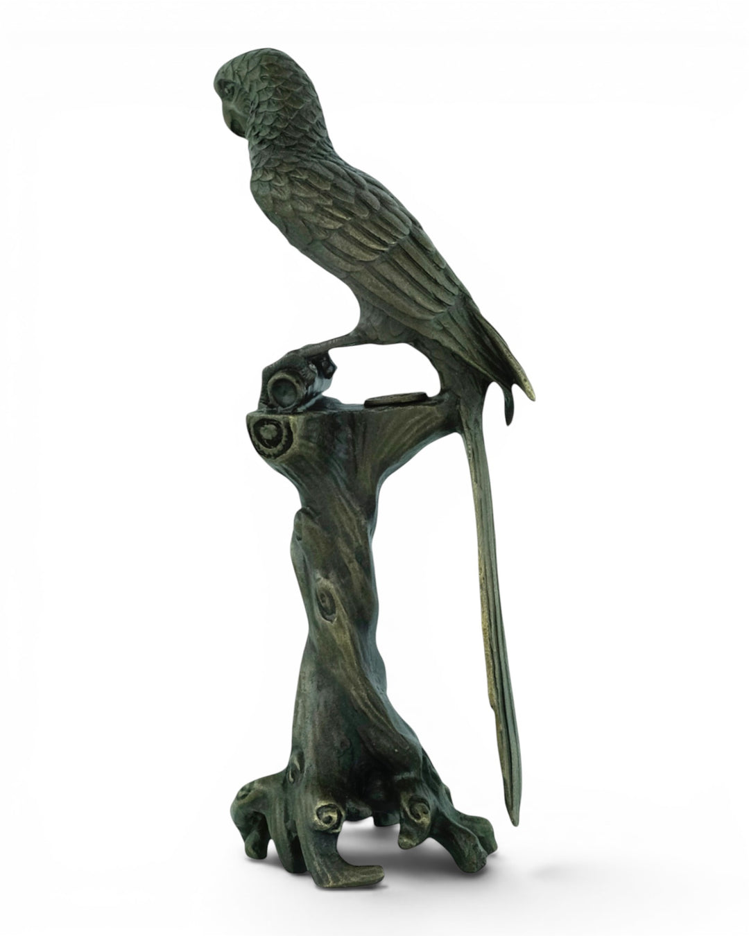 Bronze sculpture of a macaw sitting on a tree trunk