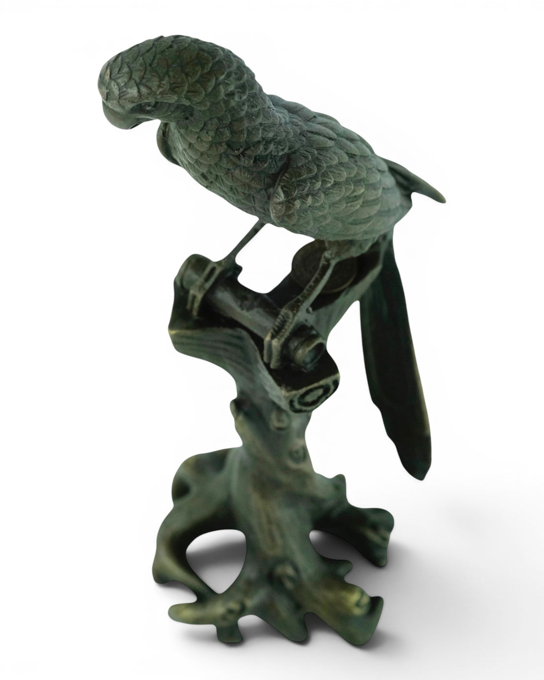 Bronze sculpture of a macaw sitting on a tree trunk