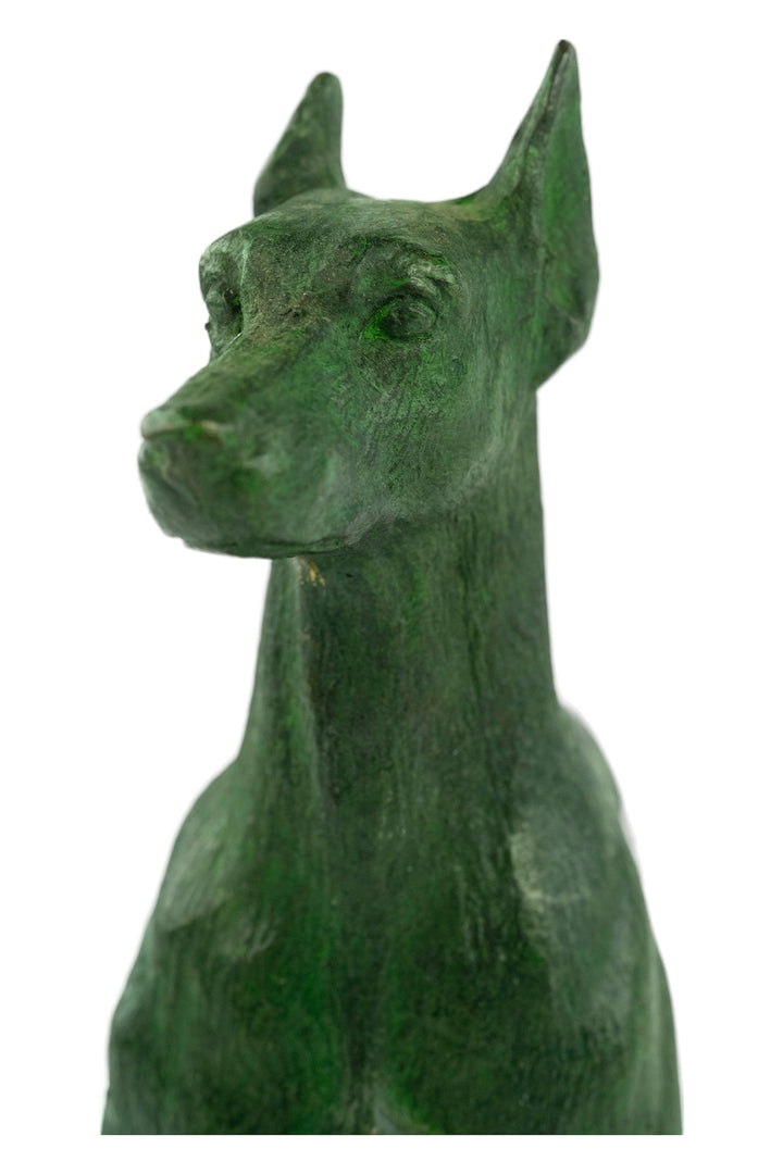 Bronze sculpture of a standing dobermann dog