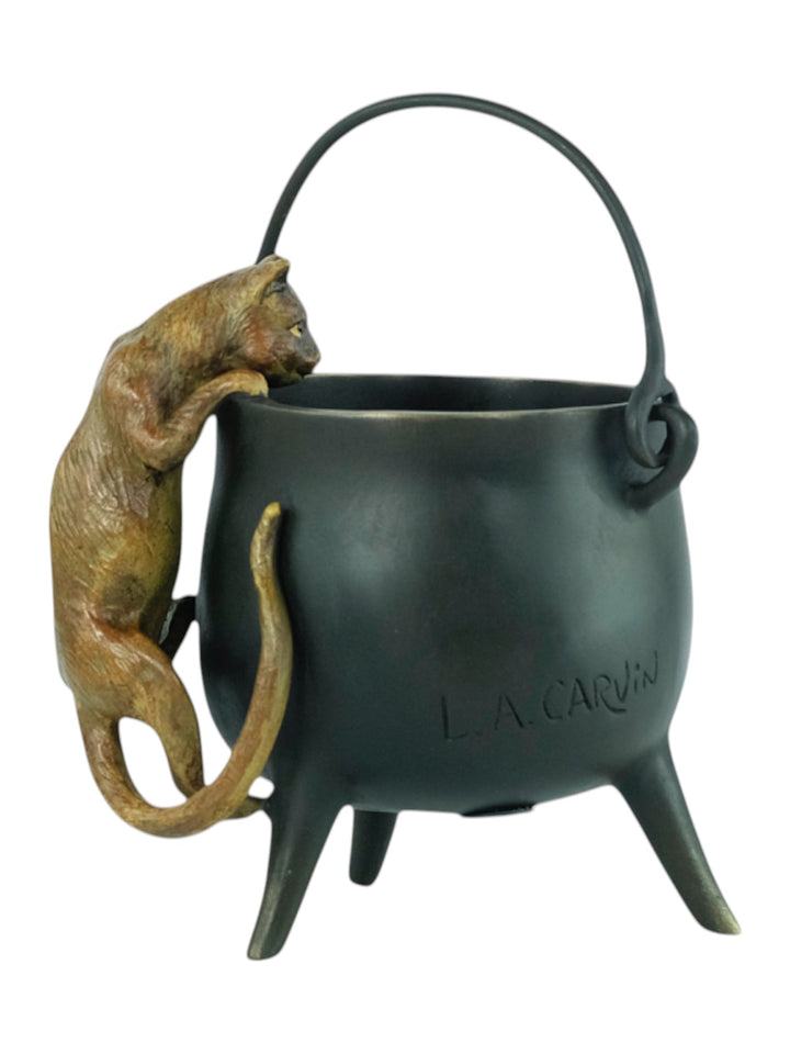 Bronze sculpture of a curious cat climbing into a cauldron