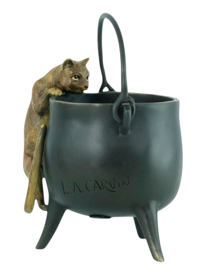 Bronze sculpture of a curious cat climbing into a cauldron