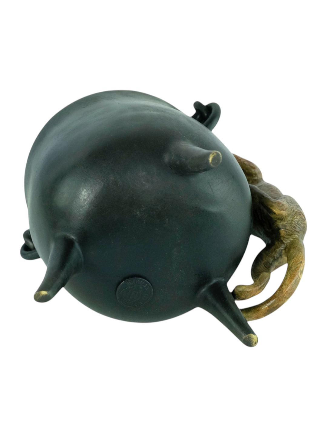 Bronze sculpture of a curious cat climbing into a cauldron