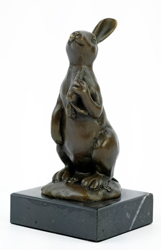 Bronze sculpture of a bunny holding a carrot