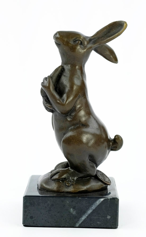 Bronze sculpture of a bunny holding a carrot