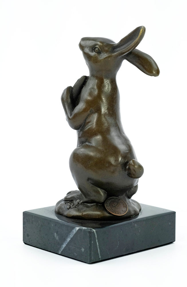 Bronze sculpture of a bunny holding a carrot