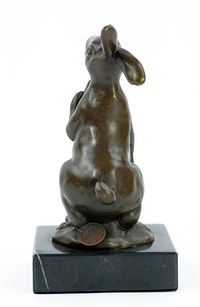 Bronze sculpture of a bunny holding a carrot
