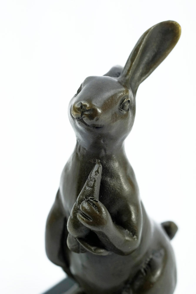 Bronze sculpture of a bunny holding a carrot