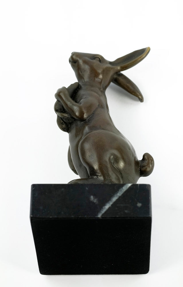 Bronze sculpture of a bunny holding a carrot