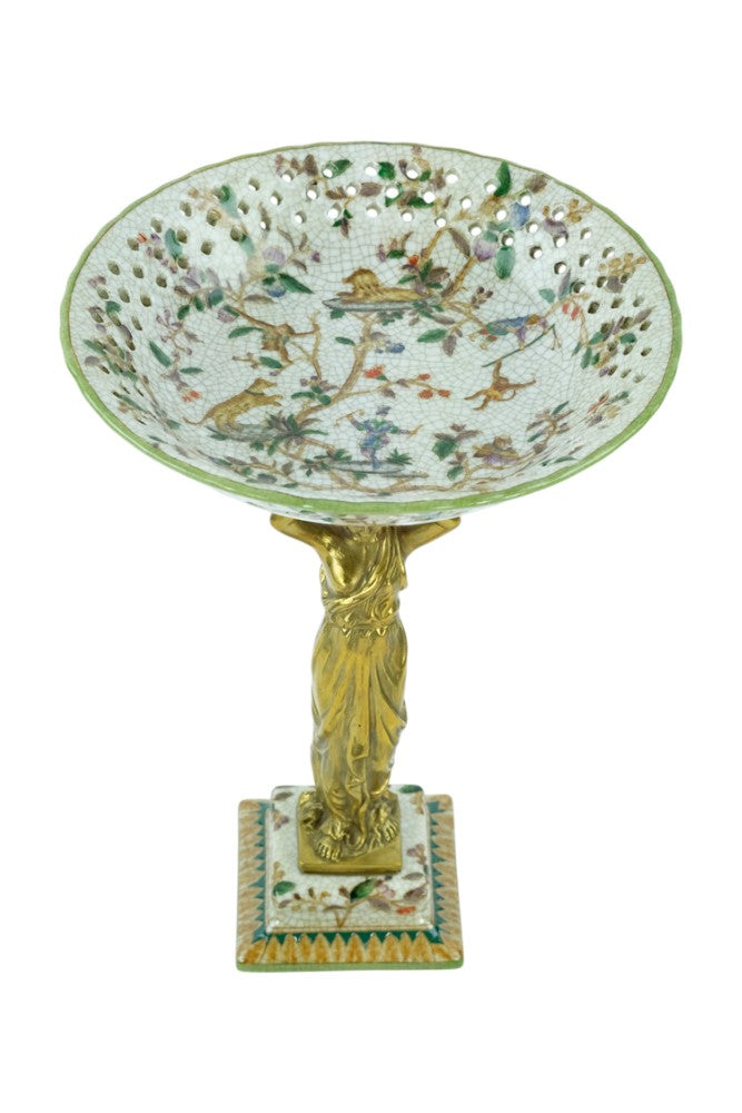 Porcelain bowl carried by a bronze female