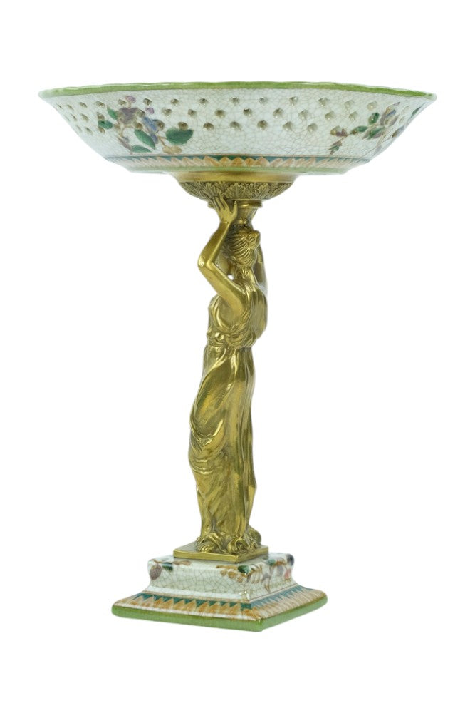 Porcelain bowl carried by a bronze female