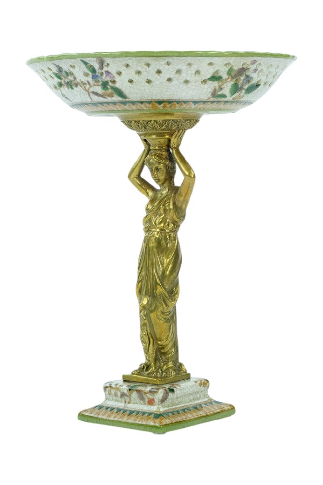 Porcelain bowl carried by a bronze female