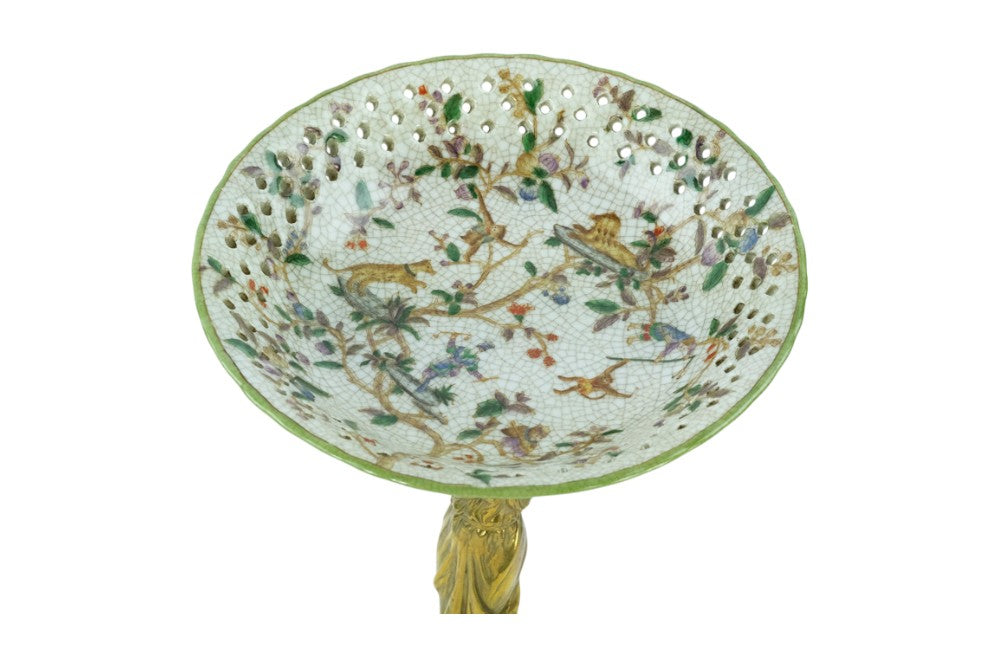 Porcelain bowl carried by a bronze female