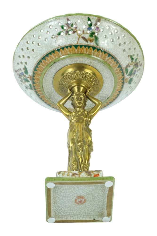Porcelain bowl carried by a bronze female