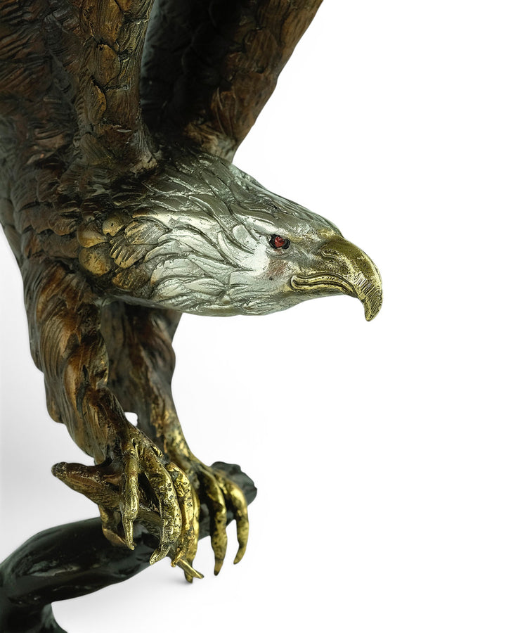 Bronze sculpture of a fishing eagle with wings spread