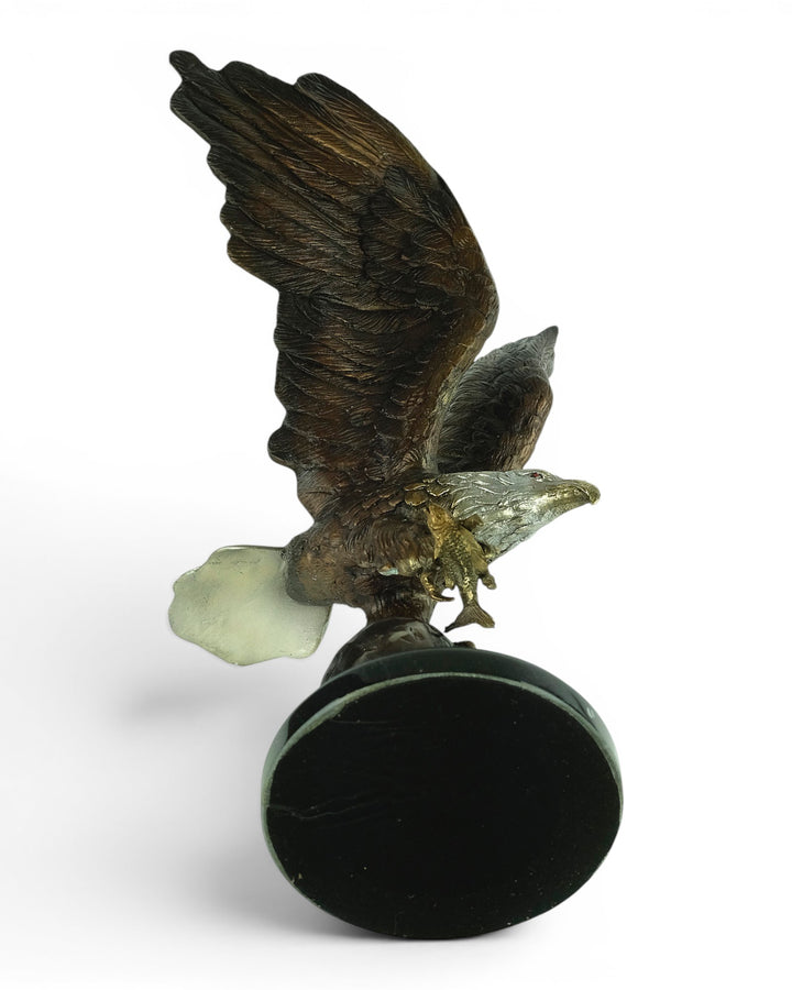 Bronze sculpture of a fishing eagle with wings spread