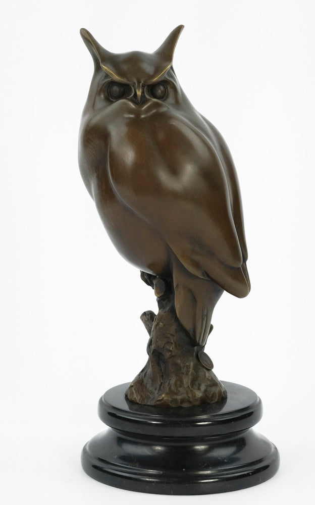 Bronze sculpture of a long-eared owl on a branch