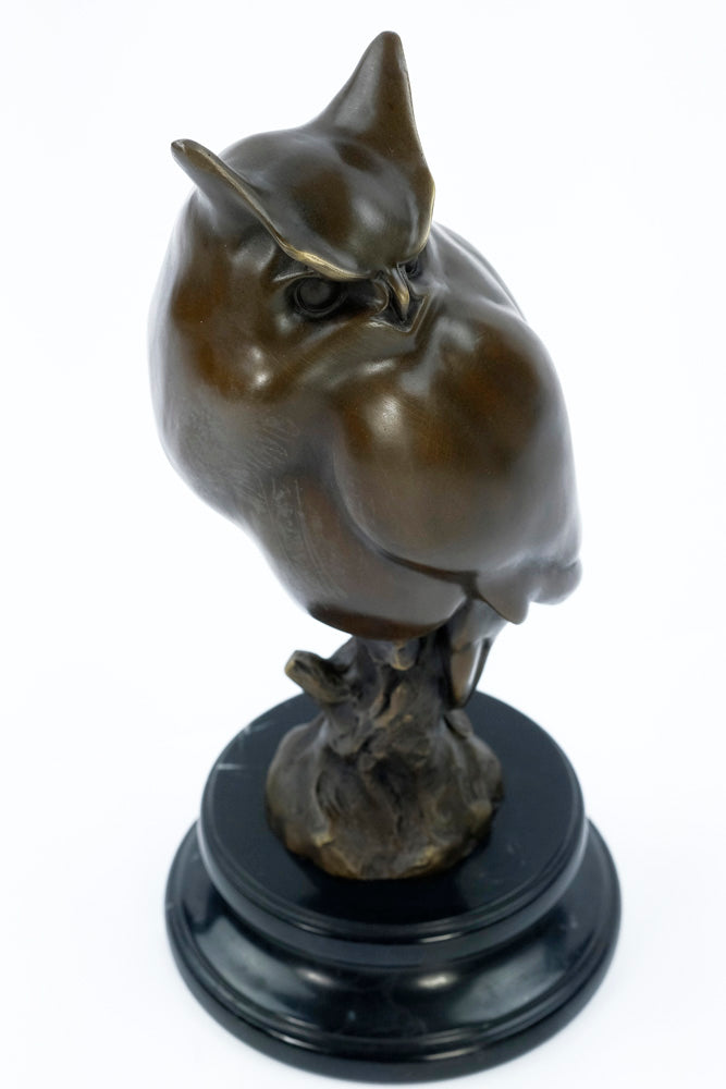 Bronze sculpture of a long-eared owl on a branch