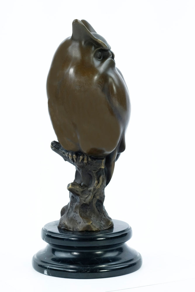 Bronze sculpture of a long-eared owl on a branch