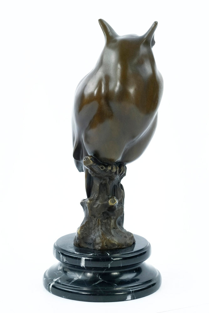 Bronze sculpture of a long-eared owl on a branch