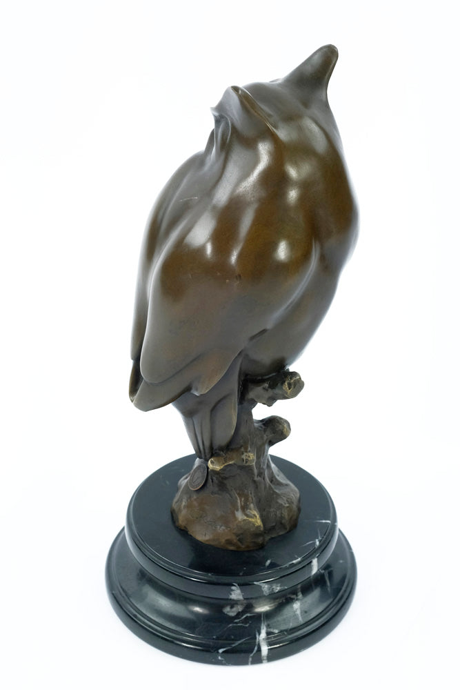 Bronze sculpture of a long-eared owl on a branch