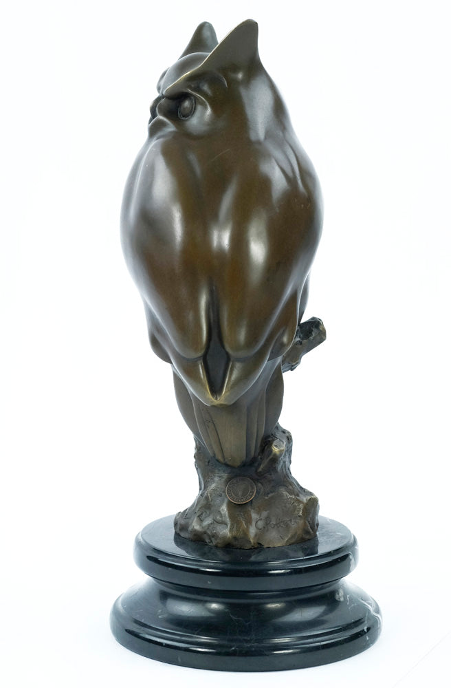 Bronze sculpture of a long-eared owl on a branch