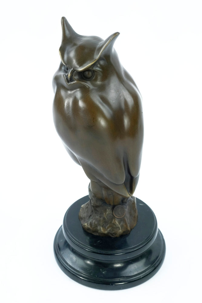 Bronze sculpture of a long-eared owl on a branch